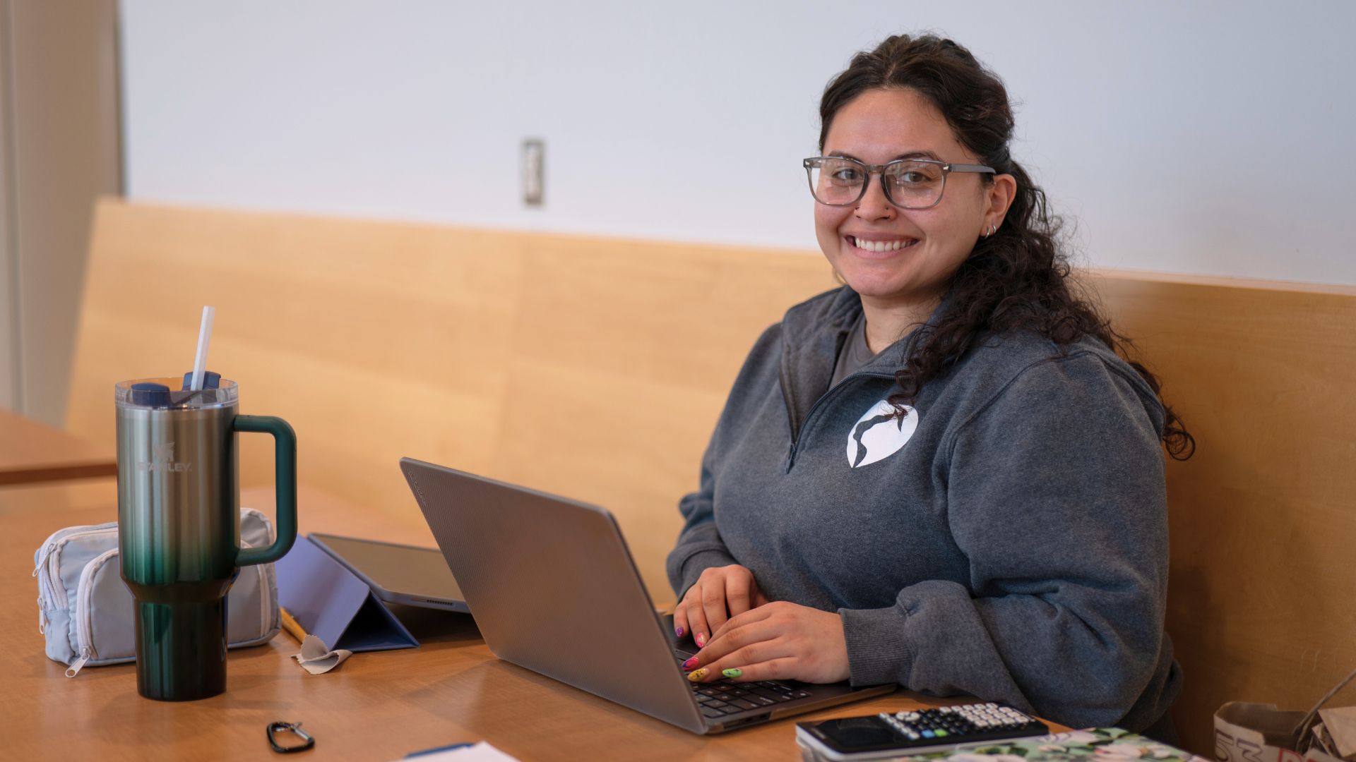Student sitting at table in the student center studying