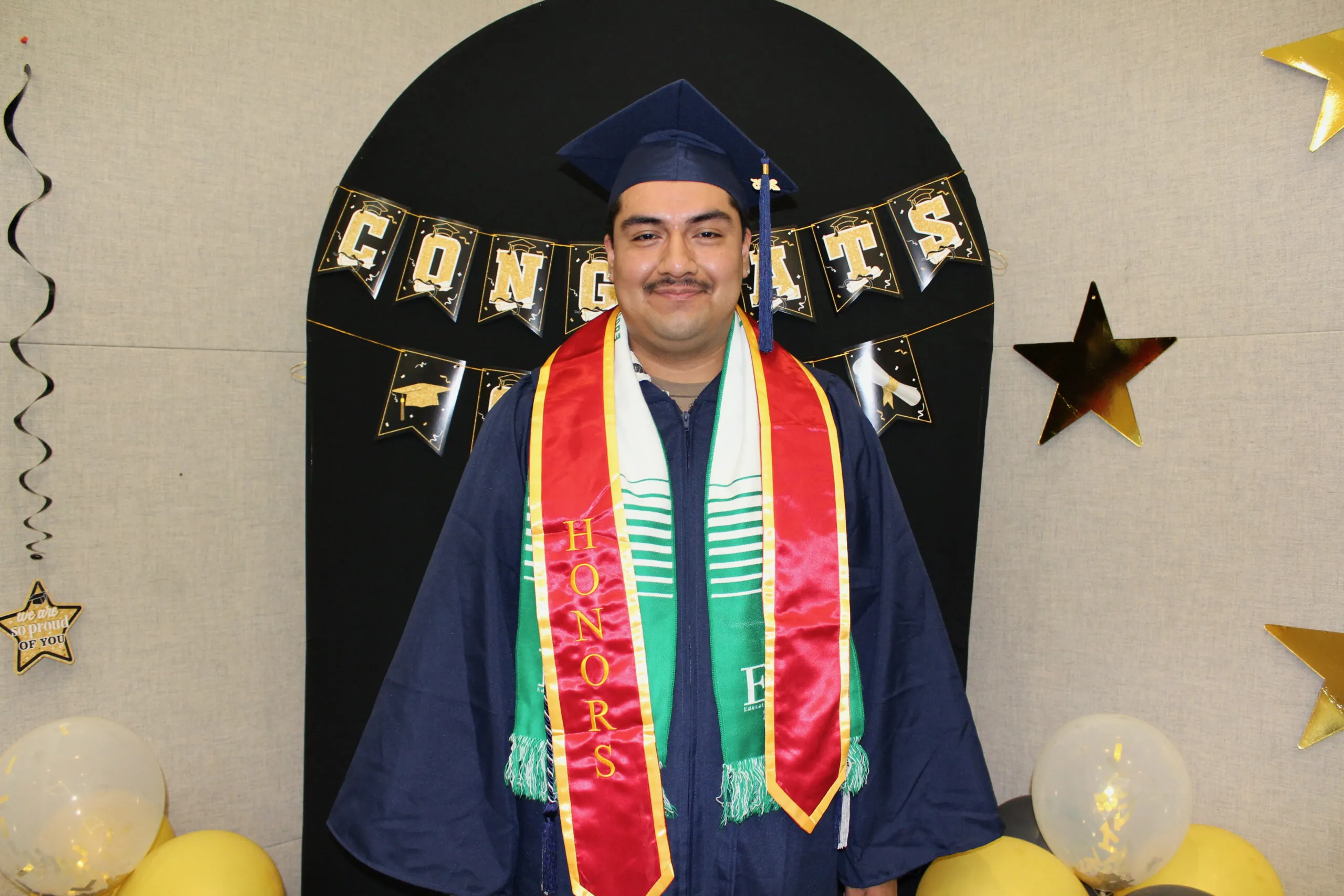 student posing in cap & gown 