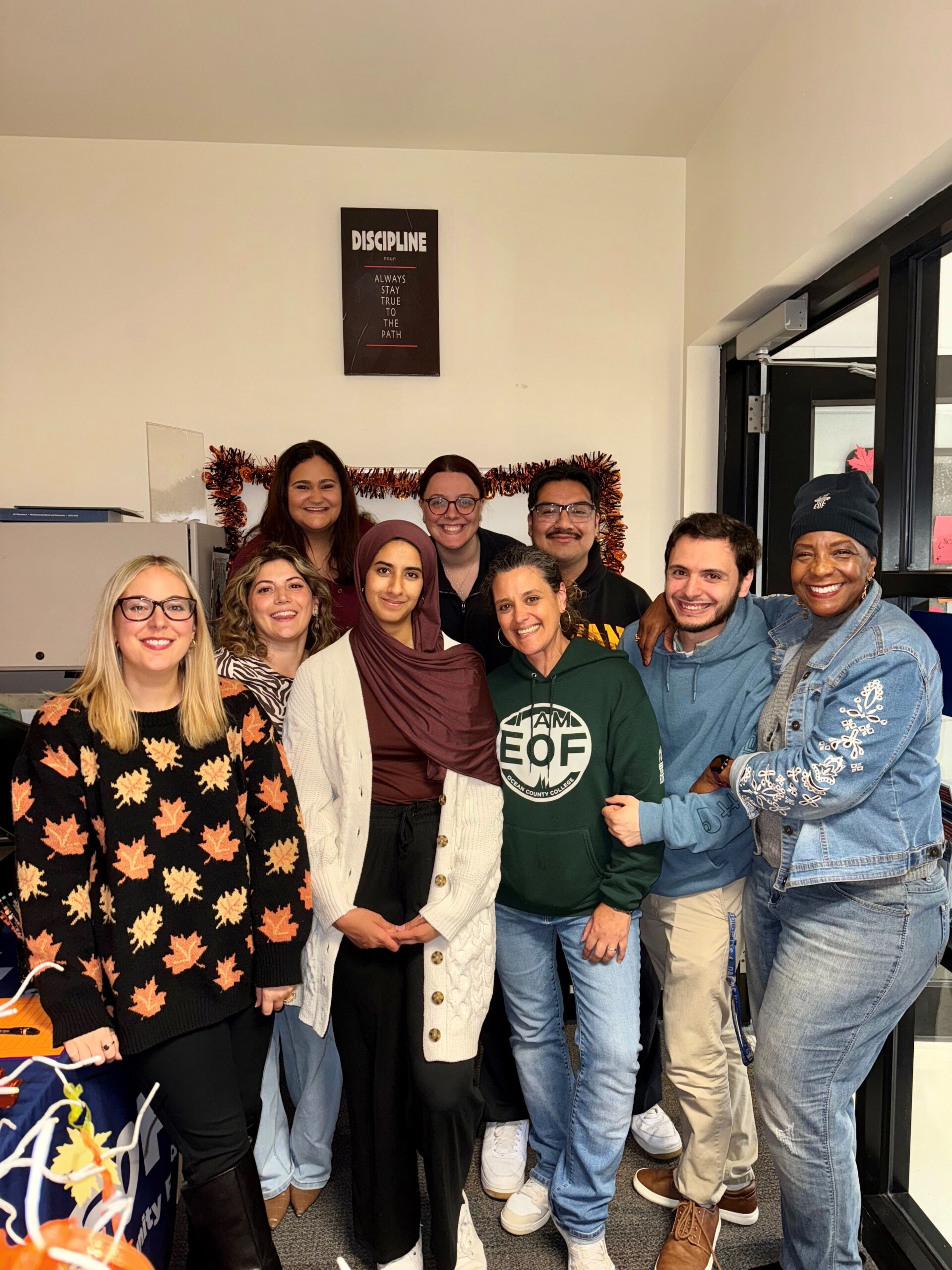 Group of EOF students and staff pose together in the EOF office. 