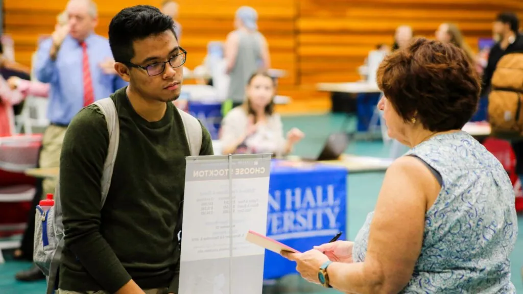 Student speaking to Seton Hall representative 