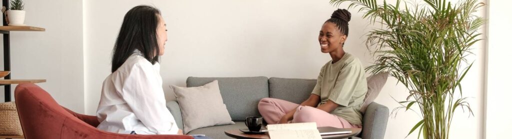 Two individuals talking in therapy session