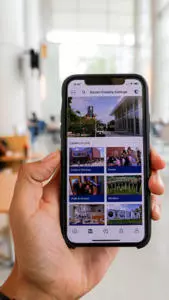 Hand holding a phone with the OCC Student App displayed
